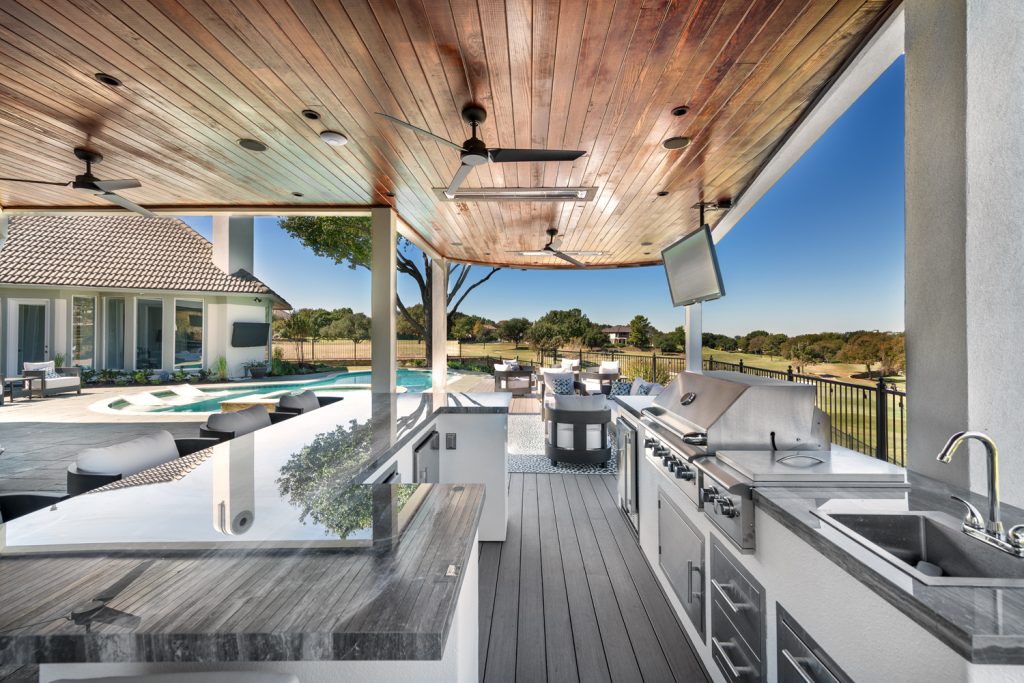 Outdoor living area with deck design and kitchen