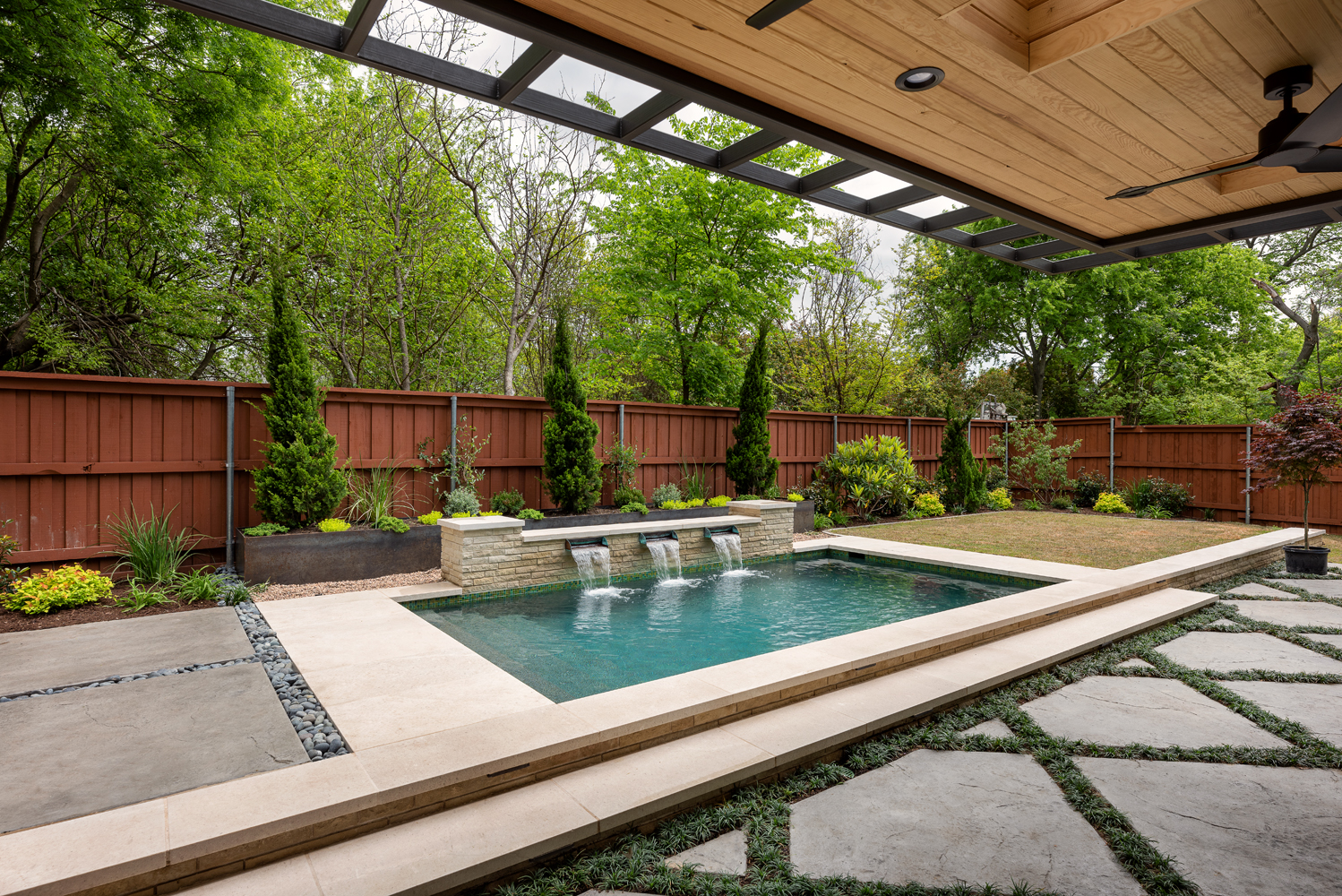 Outdoor pool with waterfall feature